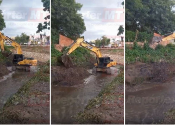 Escavadeira da Prefeitura é flagrada jogando barro de um lado pro outro dentro de córrego em Cuiabá